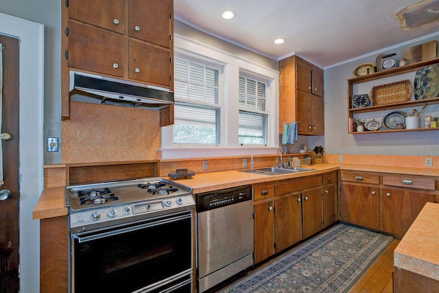 kitchen featuring open shelves, under cabinet range hood, gas range oven, stainless steel dishwasher, and a sink