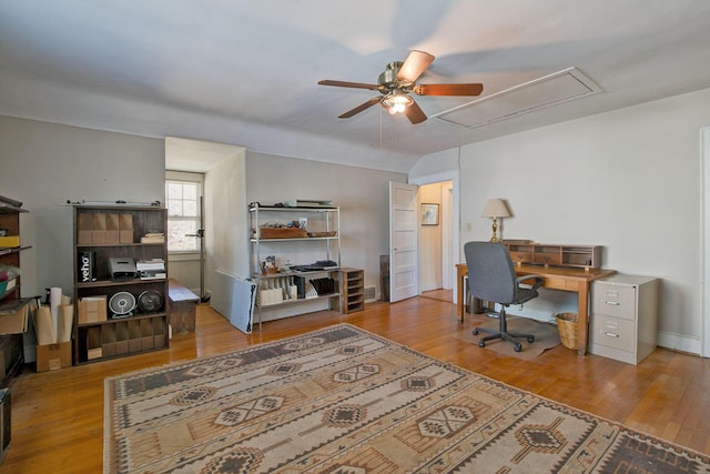 office featuring wood finished floors, attic access, and ceiling fan