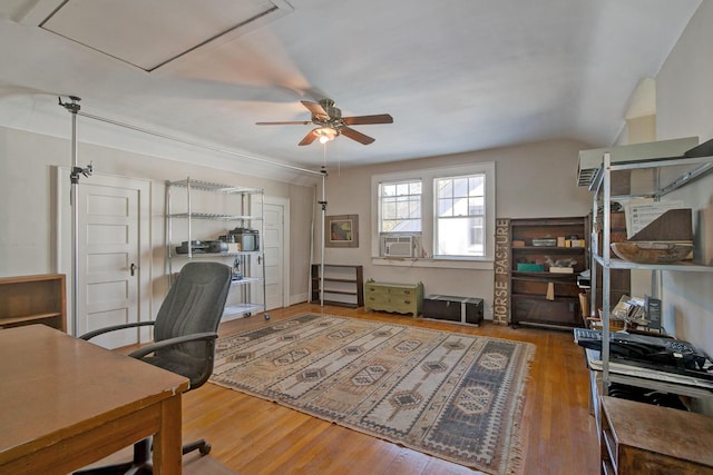 office area featuring cooling unit, attic access, a ceiling fan, and wood finished floors