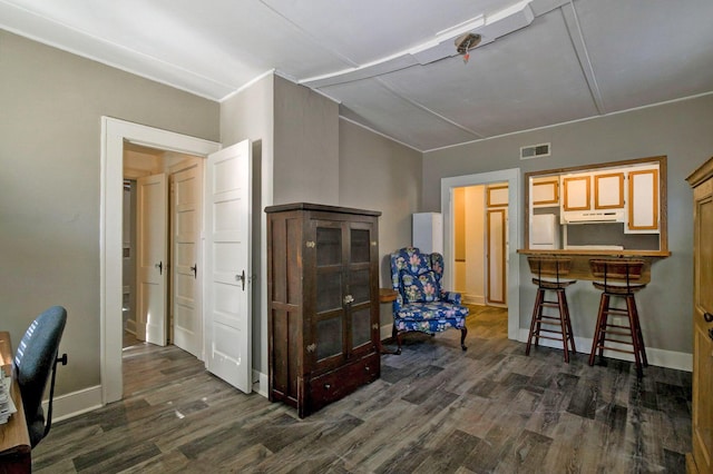 office space with dark wood finished floors, visible vents, baseboards, and lofted ceiling