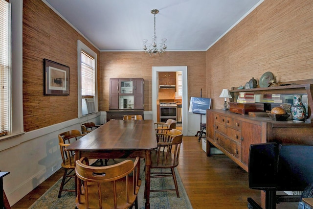 dining room featuring a chandelier, dark wood-style floors, and ornamental molding