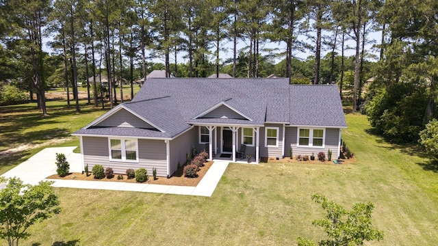 409 Pine Lake Ct, Manning, SC 29102 - view of front of property with a front lawn, concrete driveway, view of scattered trees, and a shingled roof