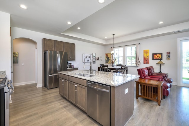 409 Pine Lake Ct, Manning, SC 29102 - kitchen featuring stainless steel appliances, a sink, arched walkways, light wood finished floors, and recessed lighting