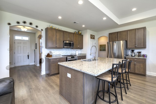 409 Pine Lake Ct, Manning, SC 29102 - kitchen with arched walkways, appliances with stainless steel finishes, a sink, a breakfast bar, and recessed lighting