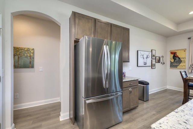 409 Pine Lake Ct, Manning, SC 29102 - kitchen featuring freestanding refrigerator, arched walkways, light wood-type flooring, baseboards, and recessed lighting