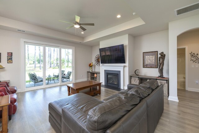 409 Pine Lake Ct, Manning, SC 29102 - living room with ceiling fan, recessed lighting, a tray ceiling, arched walkways, and baseboards