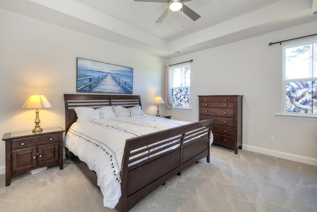 409 Pine Lake Ct, Manning, SC 29102 - bedroom with light carpet, baseboards, a raised ceiling, and ceiling fan