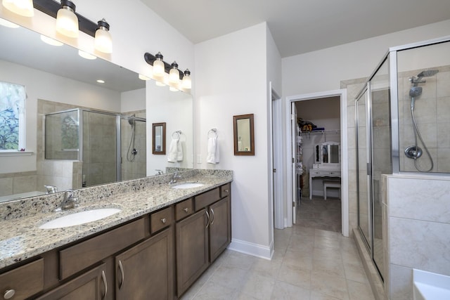 409 Pine Lake Ct, Manning, SC 29102 - bathroom featuring a stall shower, a walk in closet, tile patterned flooring, and double vanity