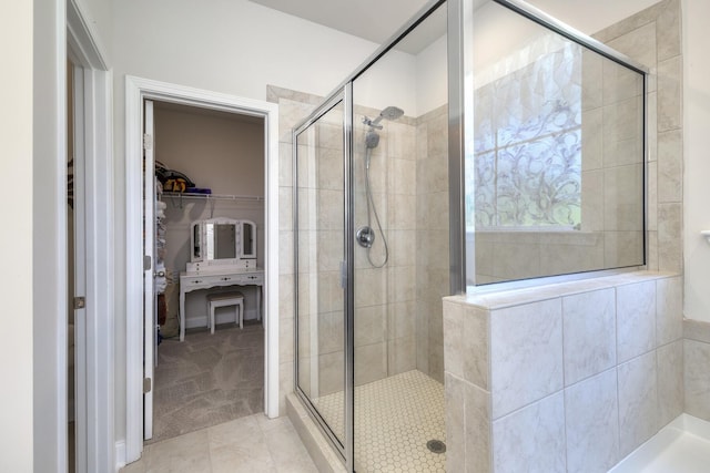 409 Pine Lake Ct, Manning, SC 29102 - bathroom with a walk in closet, a stall shower, and tile patterned floors