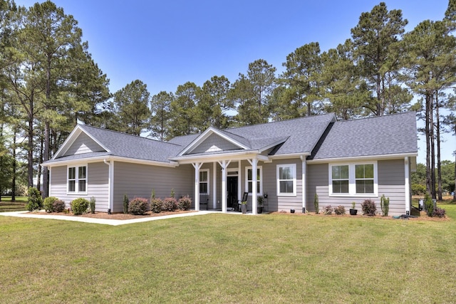 409 Pine Lake Ct, Manning, SC 29102 - ranch-style home featuring a front lawn and a shingled roof