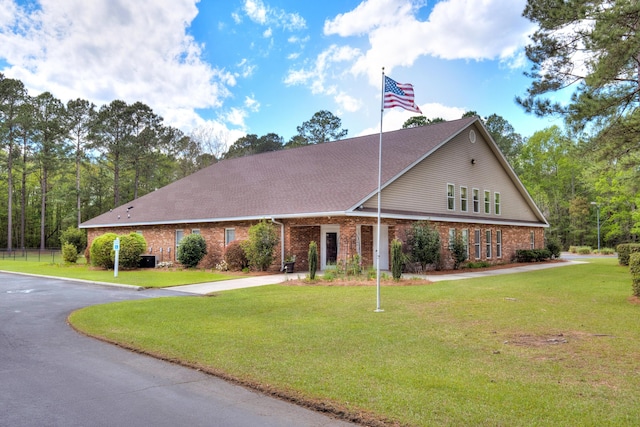 409 Pine Lake Ct, Manning, SC 29102 - view of front facade featuring driveway, brick siding, a front yard, and roof with shingles