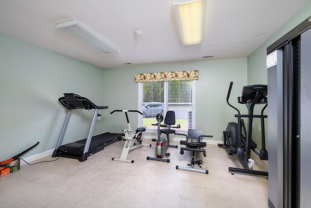 409 Pine Lake Ct, Manning, SC 29102 - exercise area featuring baseboards and a textured ceiling