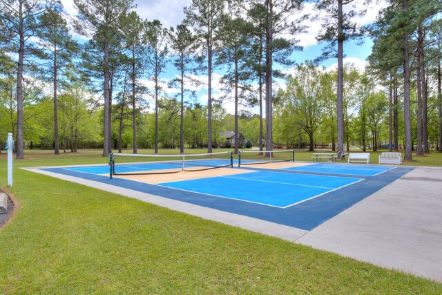409 Pine Lake Ct, Manning, SC 29102 - view of sport court with a tennis court, a lawn, view of scattered trees, and community basketball court