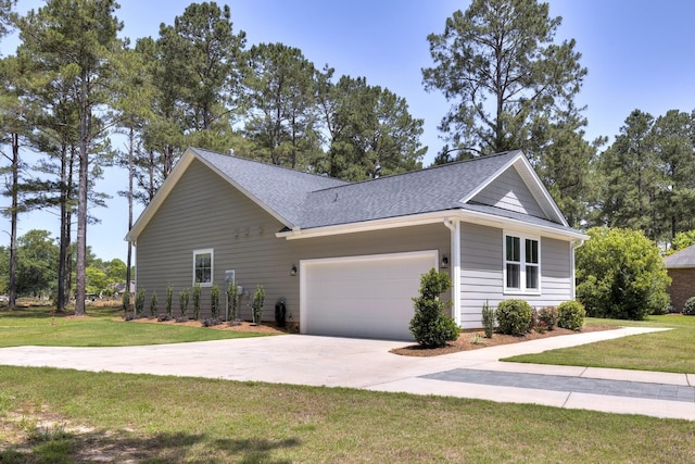 409 Pine Lake Ct, Manning, SC 29102 - view of side of home with a lawn, roof with shingles, driveway, and an attached garage