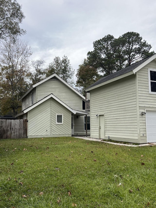 back of house with a lawn