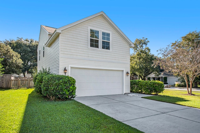 view of side of property with a garage and a lawn