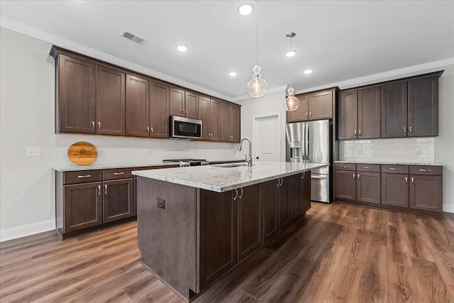 kitchen featuring hanging light fixtures, stainless steel appliances, dark hardwood / wood-style floors, and sink