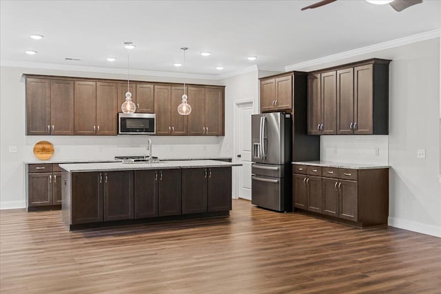 kitchen with decorative light fixtures, stainless steel appliances, dark brown cabinets, and dark wood-type flooring