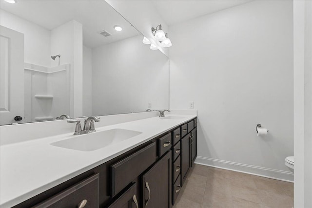 bathroom with tile patterned floors, vanity, and toilet