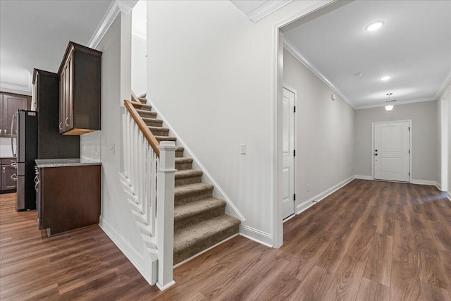 foyer with dark hardwood / wood-style flooring and crown molding