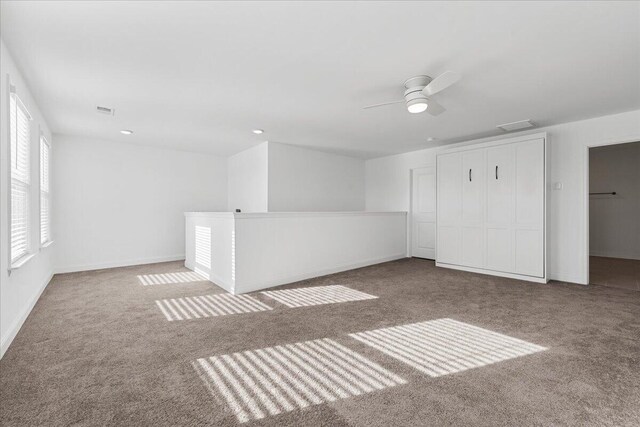 empty room with light carpet and ceiling fan