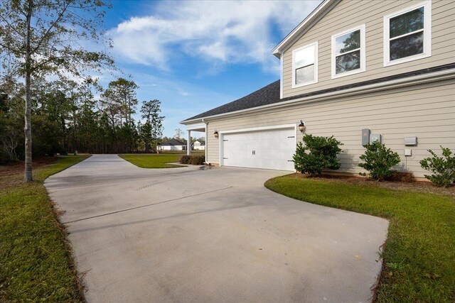 view of property exterior with a garage and a yard