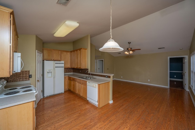 kitchen featuring visible vents, light wood-type flooring, lofted ceiling, a peninsula, and white appliances