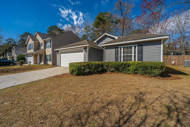 view of front of home with a front lawn, fence, concrete driveway, cooling unit, and an attached garage