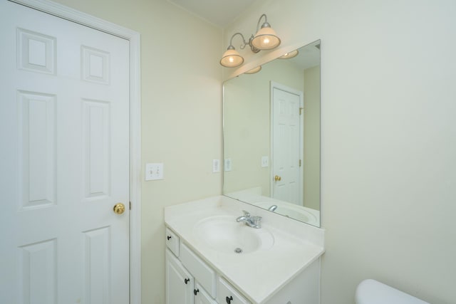 half bathroom with vanity and toilet