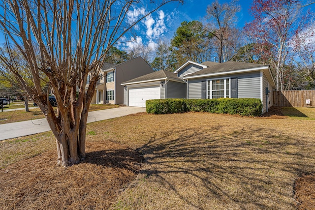 ranch-style home featuring an attached garage, concrete driveway, a front yard, and fence