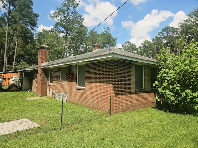 8719 Jefferies Hwy, Walterboro, SC 29488 - view of home's exterior featuring a chimney, a lawn, and brick siding