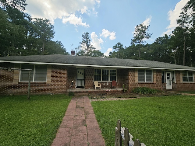 8719 Jefferies Hwy, Walterboro, SC 29488 - ranch-style house with a porch, a front lawn, and brick siding