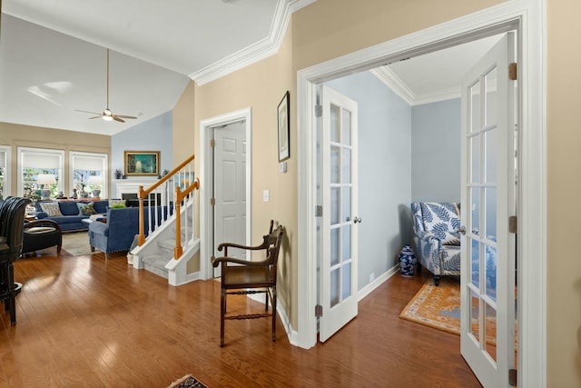 entryway with ornamental molding, french doors, stairway, and wood finished floors