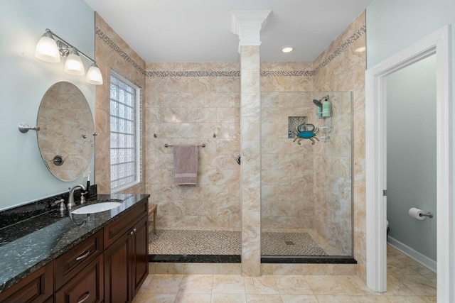 bathroom with vanity, toilet, and walk in shower