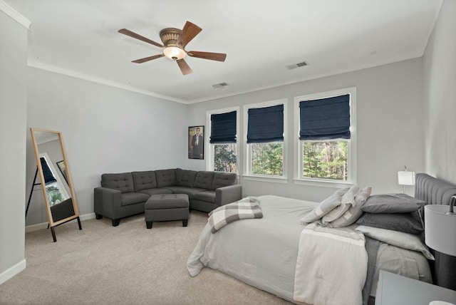 carpeted bedroom with baseboards, visible vents, and crown molding