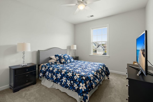 carpeted bedroom with baseboards, visible vents, and ceiling fan