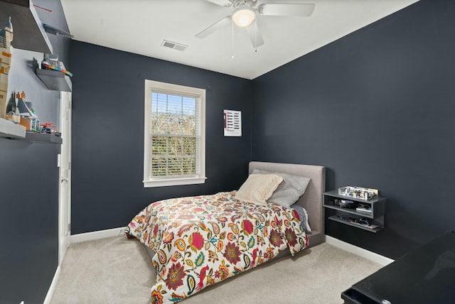 carpeted bedroom featuring a ceiling fan, visible vents, and baseboards