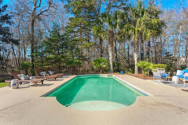 view of swimming pool with a patio area, fence, and a fenced in pool