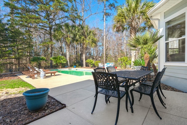 view of patio / terrace featuring fence, a fenced in pool, and outdoor dining space