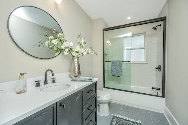 bathroom featuring vanity, recessed lighting, tile patterned floors, toilet, and bath / shower combo with glass door