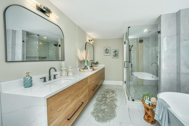 bathroom with a freestanding bath, a sink, double vanity, marble finish floor, and a stall shower