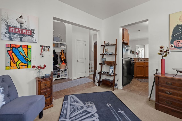 216 Goldfinch Ln, Summerville, SC 29485 - living area with arched walkways, light tile patterned floors, baseboards, and light carpet