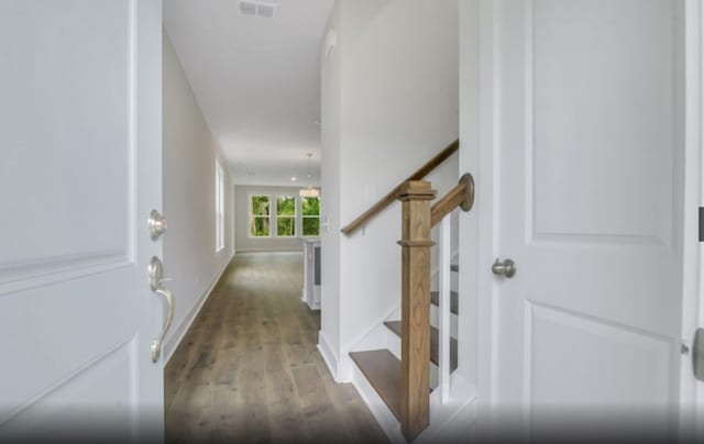 stairway featuring hardwood / wood-style flooring