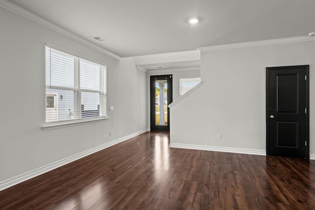 spare room featuring dark hardwood / wood-style flooring and ornamental molding