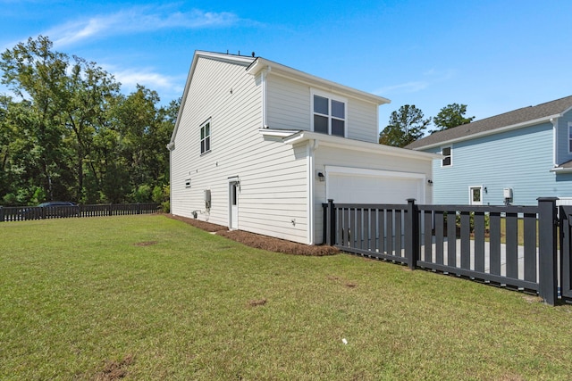 exterior space with a garage and a lawn