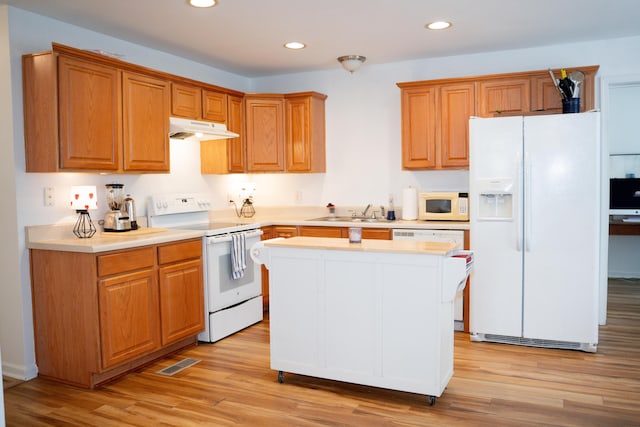 kitchen with white appliances, light wood finished floors, visible vents, under cabinet range hood, and recessed lighting