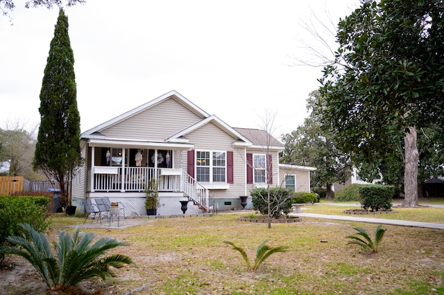 view of front of home with covered porch, crawl space, and a front yard