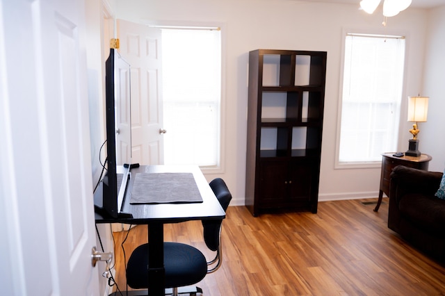 home office featuring light wood-style flooring and baseboards