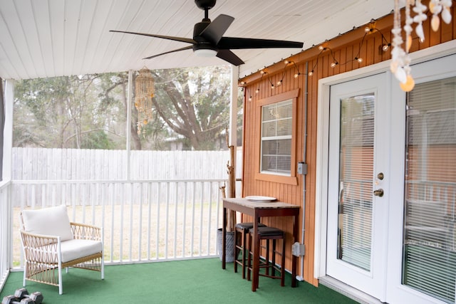 sunroom / solarium with wooden ceiling and ceiling fan