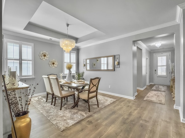 209 Celestial Blvd, Summerville, SC 29486 - dining space with a chandelier, baseboards, wood finished floors, crown molding, and a tray ceiling